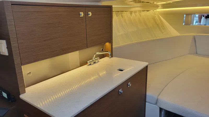 Slide: The Image of 2023 Jeanneau LEADER 9.0WA interior with modern kitchenette and cozy seating area. - 13