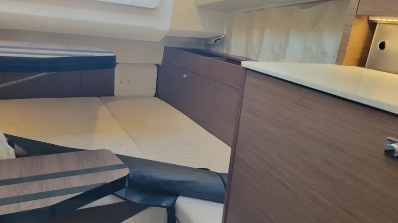 Slide: The Image of Interior cabin of 2023 Jeanneau LEADER 9.0WA, featuring modern wood finishes and seating. - 14