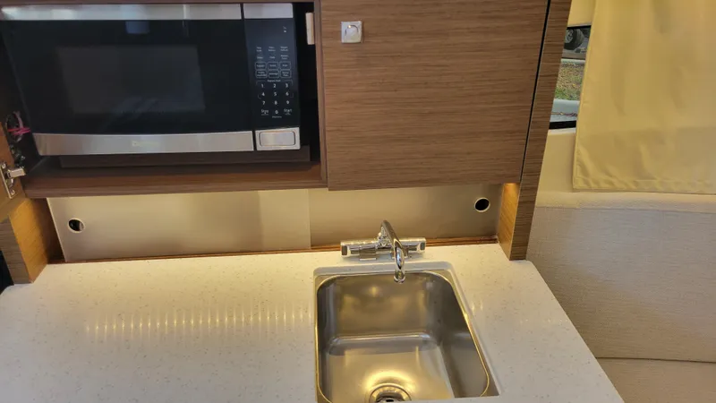 Slide: The Image of Modern kitchenette in 2023 Jeanneau LEADER 9.0WA with microwave and sink. - 15