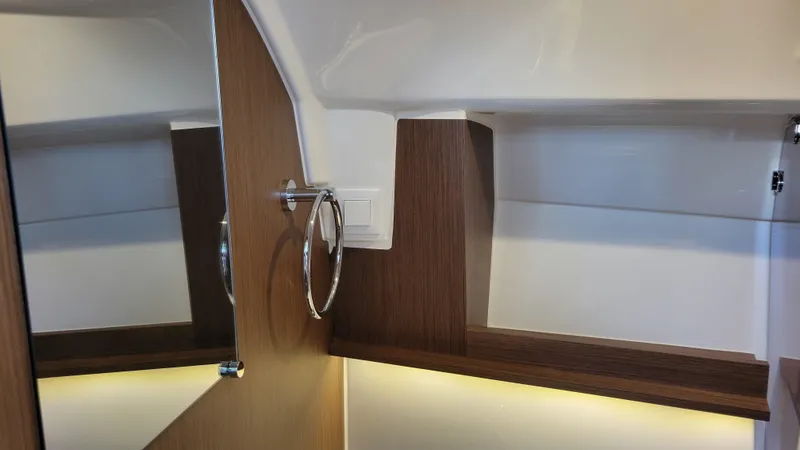 Slide: The Image of 2023 Jeanneau LEADER 9.0WA interior with wood accents and modern design. - 17