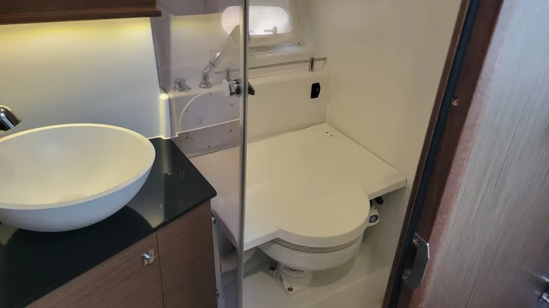 Slide: The Image of 2023 Jeanneau LEADER 9.0WA boat bathroom with modern sink and toilet. - 18