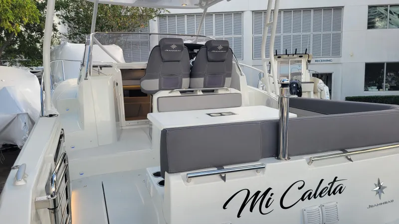 Slide: The Image of 2023 Jeanneau LEADER 9.0WA boat interior with seating, labeled "Mi Caleta." - 2