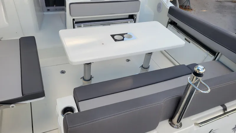 Slide: The Image of 2023 Jeanneau LEADER 9.0WA boat interior with seating and table. - 5