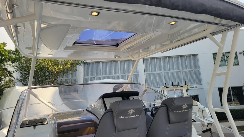 Slide: The Image of 2023 Jeanneau LEADER 9.0WA boat interior with modern seating and sunroof. - 7