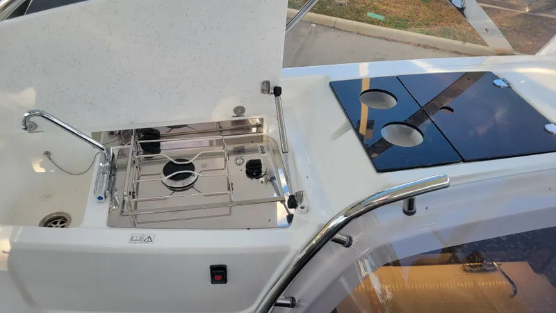 Slide: The Image of 2023 Jeanneau LEADER 9.0WA boat kitchen with stove and sink. - 8