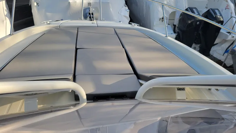 Slide: The Image of 2023 Jeanneau LEADER 9.0WA boat with cushioned deck seating. - 9