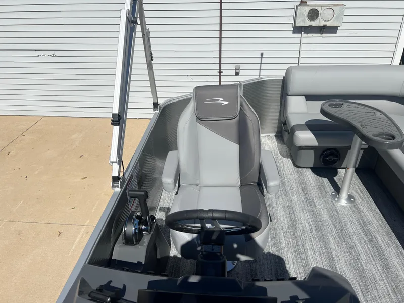 Slide: The Image of 2025 Bennington 20 SL boat interior with steering wheel and seating area. - 18
