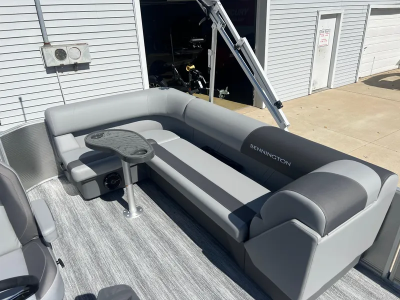 Slide: The Image of 2025 Bennington 20 SL pontoon boat with gray seating and table. - 19