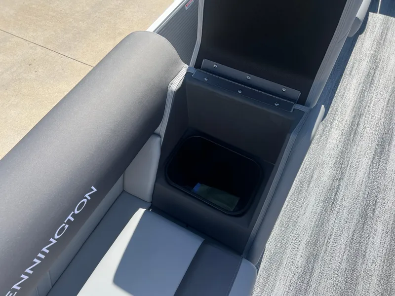 Slide: The Image of 2025 Bennington 20 SL boat interior with storage compartment and cushioned seating. - 21