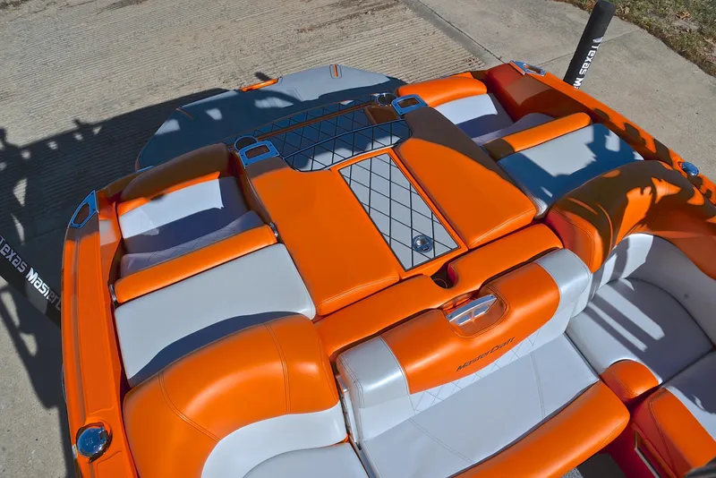 Slide: The Image of 2015 MasterCraft X23 boat interior with orange and gray seating. - 24