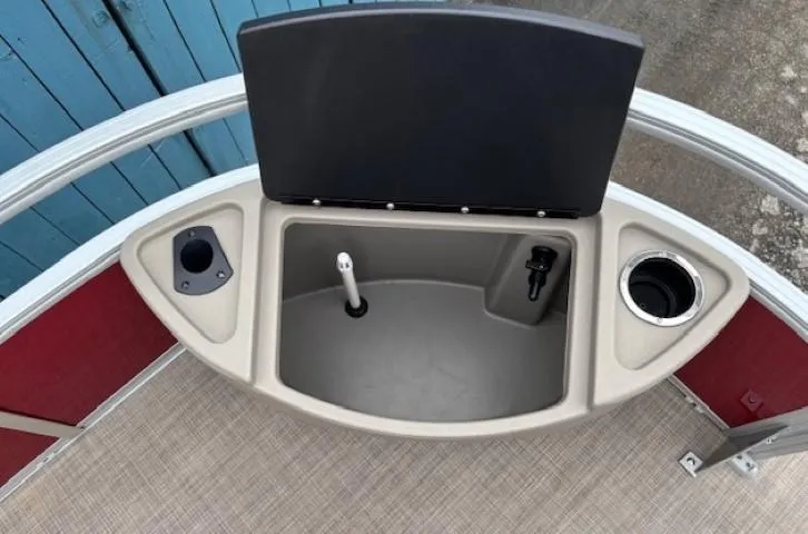 Slide: The Image of 2022 Sun Tracker Bass Buggy 18 DLX boat storage compartment with cup holders. - 11