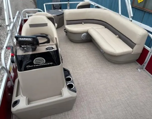 Slide: The Image of 2022 Sun Tracker Bass Buggy 18 DLX pontoon boat interior with beige seating and Garmin system. - 12
