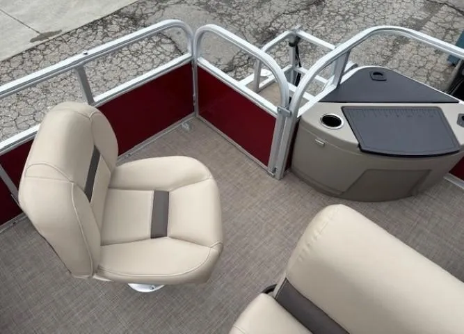 Slide: The Image of 2022 Sun Tracker Bass Buggy 18 DLX interior with beige seating and red paneling. - 23