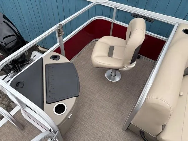Slide: The Image of 2022 Sun Tracker Bass Buggy 18 DLX interior with beige seating and fishing station. - 25