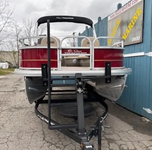 Slide: The Image of 2022 Sun Tracker Bass Buggy 18 DLX pontoon boat on trailer, parked outdoors. - 3