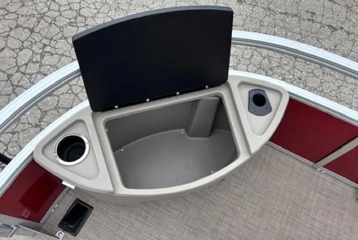 Slide: The Image of 2022 Sun Tracker Bass Buggy 18 DLX storage compartment with cup holders and open lid. - 9