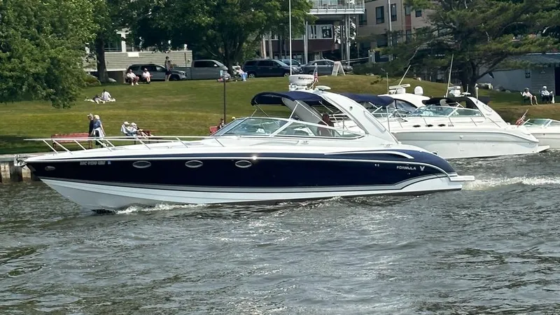 The Image of 2014 Formula 370 Super Sport boat cruising on a scenic river. - 0