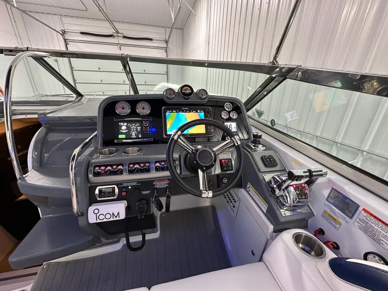 Slide: The Image of 2014 Formula 370 Super Sport boat cockpit with advanced navigation controls and steering wheel. - 11