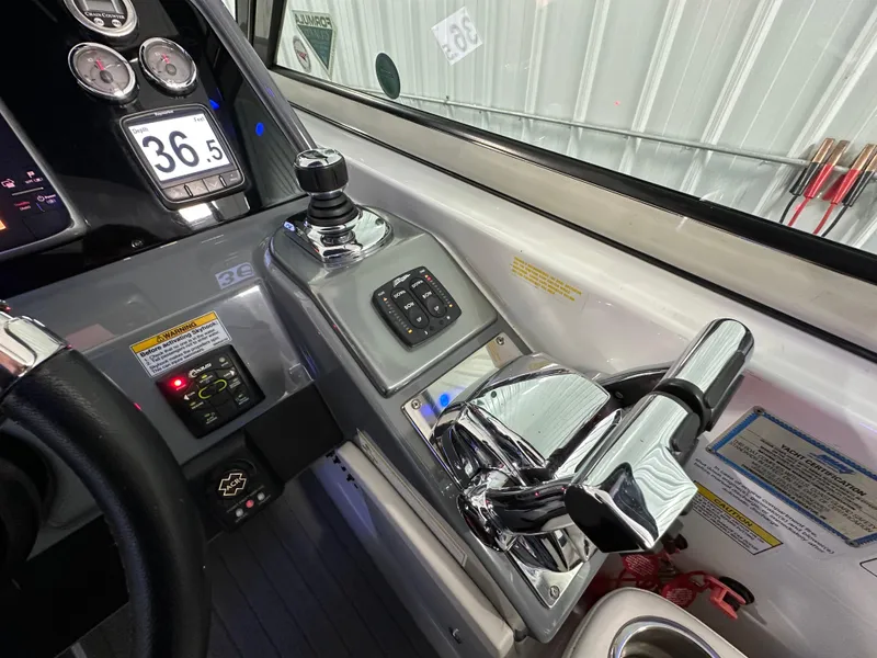 Slide: The Image of Control panel of a 2014 Formula 370 Super Sport boat with chrome throttle levers. - 12