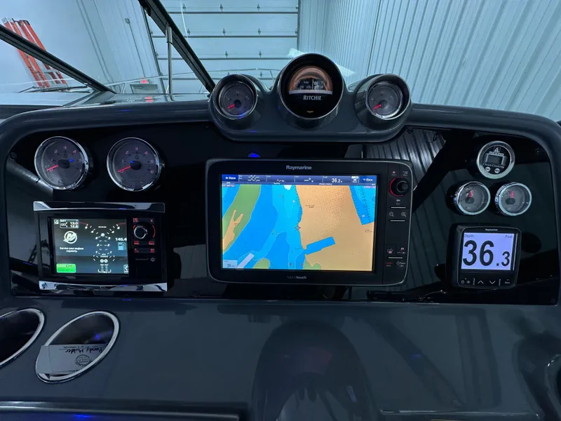 Slide: The Image of Dashboard of a 2014 Formula 370 Super Sport boat with navigation and gauges. - 13