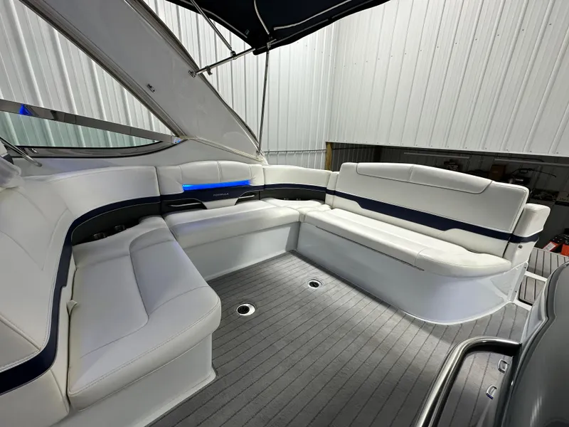 Slide: The Image of 2014 Formula 370 Super Sport boat interior with white seating and sleek design. - 4