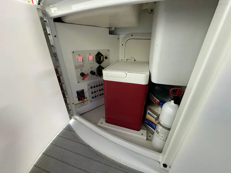 Slide: The Image of 2014 Formula 370 Super Sport storage compartment with cooler, fire extinguisher, and control panel. - 8