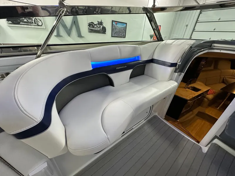 Slide: The Image of 2014 Formula 370 Super Sport boat interior with white seating and blue accent lighting. - 9