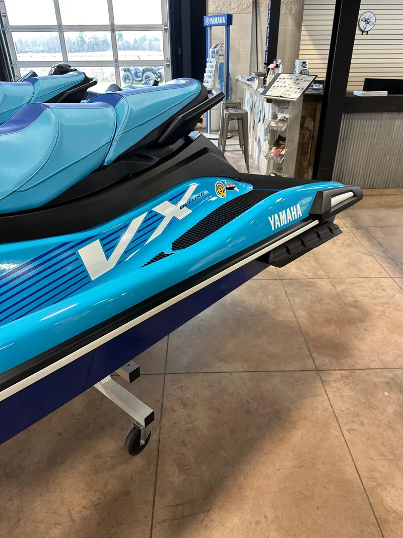 Slide: The Image of 2025 Yamaha WaveRunner VX Deluxe in showroom, featuring sleek blue design. - 3