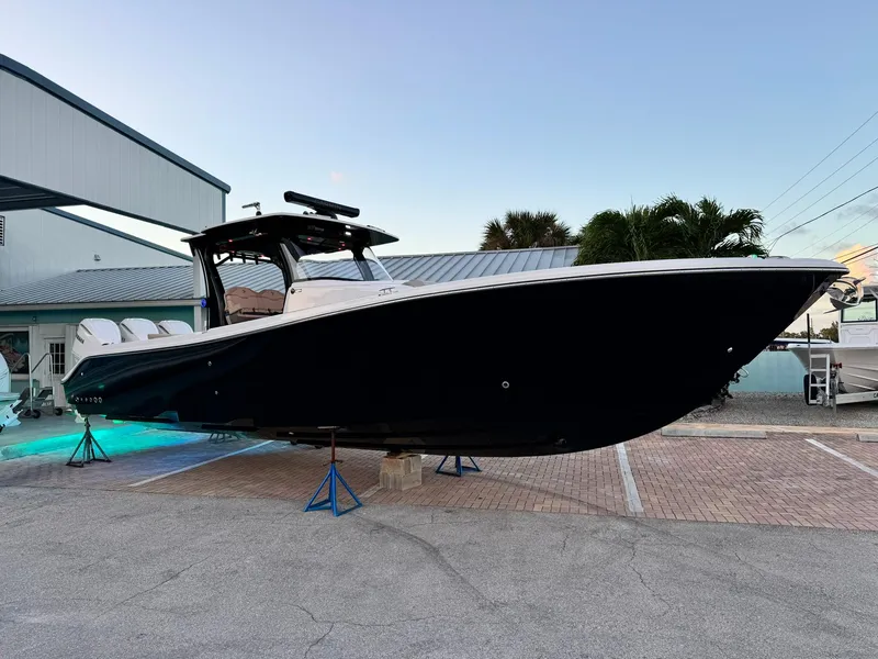 The Image of 2025 Edgewater 370 CC boat displayed outdoors at sunset. - 0