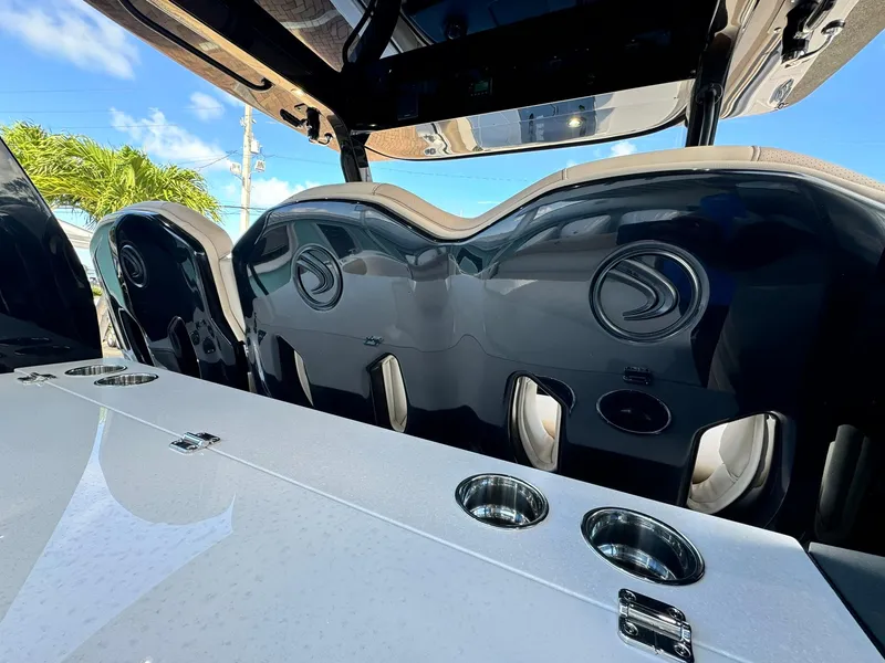 Slide: The Image of 2025 Edgewater 370 CC boat interior with sleek seating and cup holders. - 10