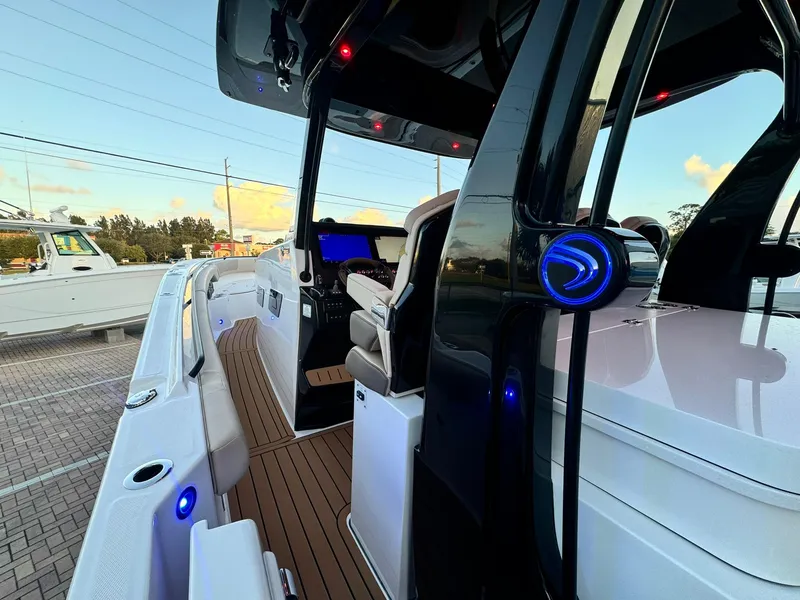Slide: The Image of 2025 Edgewater 370 CC boat interior with modern design and ambient lighting. - 13