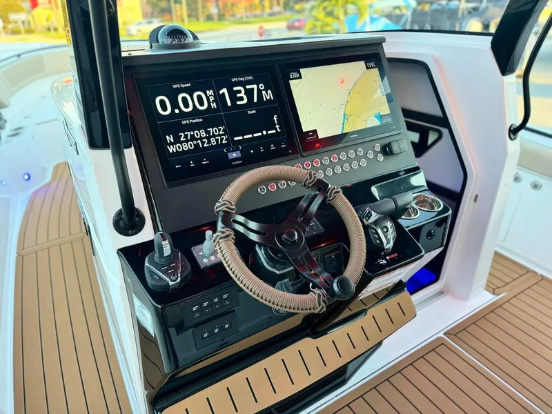 Slide: The Image of 2025 Edgewater 370 CC helm with advanced navigation and control systems. - 14