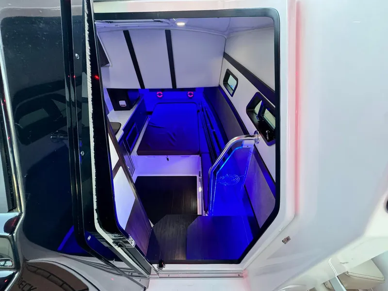Slide: The Image of Interior view of 2025 Edgewater 370 CC boat with modern blue lighting. - 16