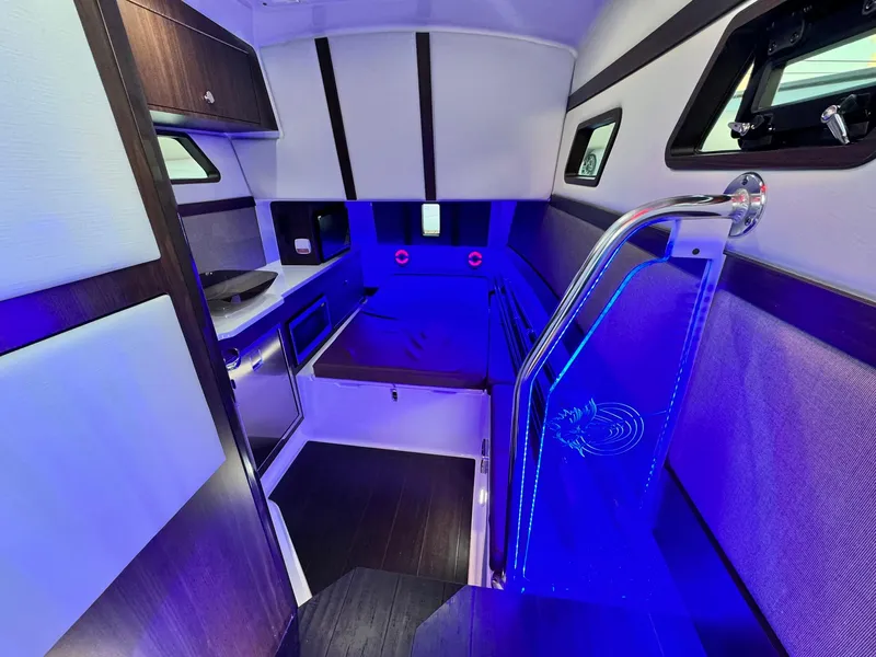 Slide: The Image of Interior of 2025 Edgewater 370 CC boat with modern lighting and sleek design. - 17