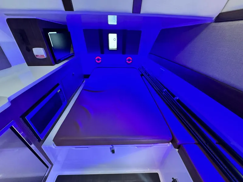 Slide: The Image of Interior cabin of 2025 Edgewater 370 CC boat with modern amenities and blue lighting. - 18