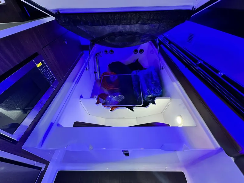Slide: The Image of Interior of 2025 Edgewater 370 CC boat with modern amenities and blue lighting. - 19