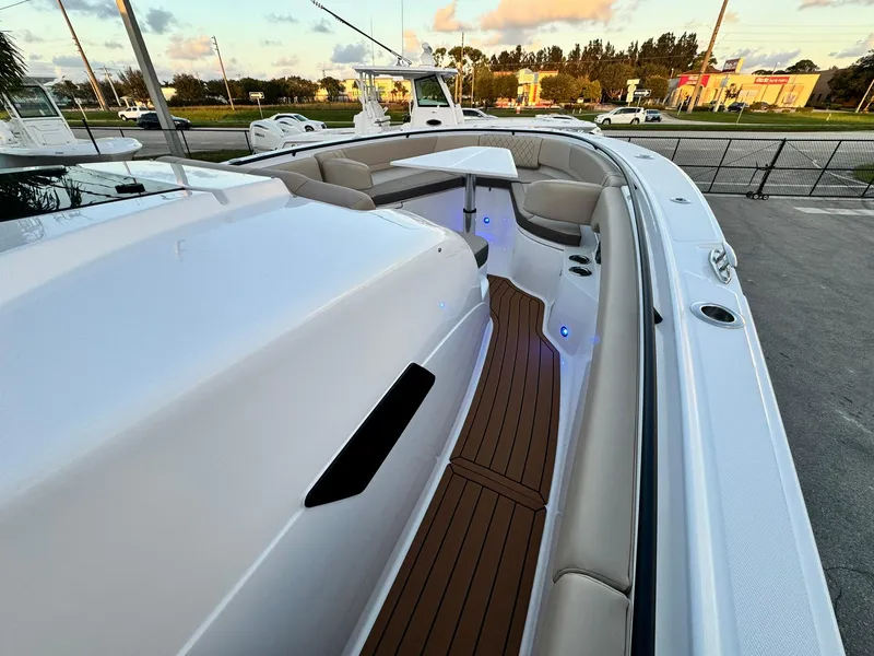 Slide: The Image of 2025 Edgewater 370 CC boat with sleek design and spacious seating area. - 24
