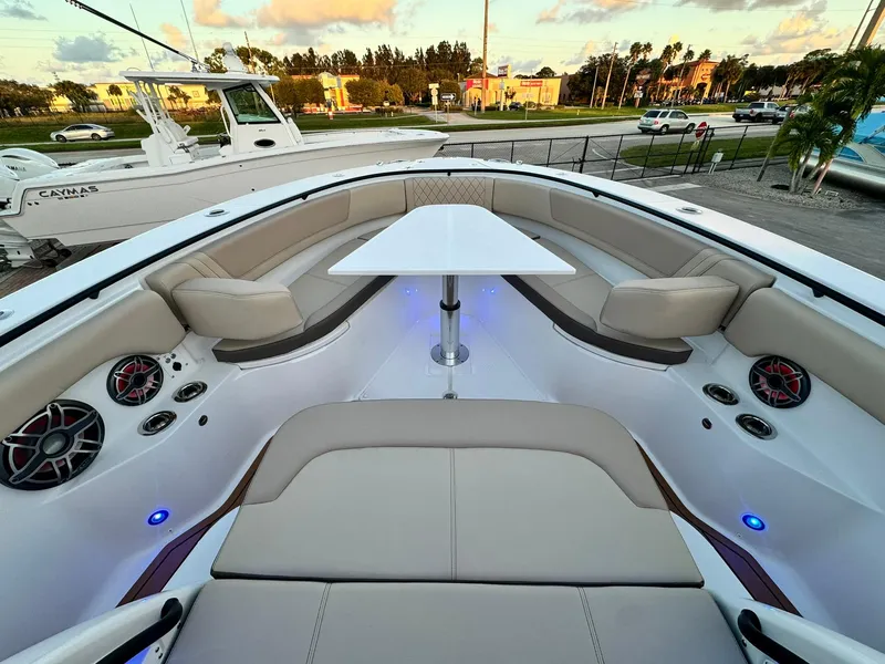 Slide: The Image of 2025 Edgewater 370 CC boat interior with seating and table, featuring modern design and lighting. - 26