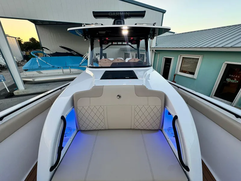Slide: The Image of 2025 Edgewater 370 CC boat with illuminated seating and modern design. - 30
