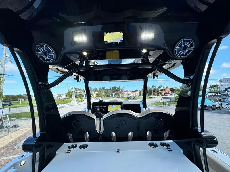 Slide: The Image of Interior view of 2025 Edgewater 370 CC boat with modern dashboard and seating. - 8
