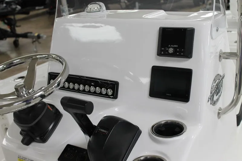 Slide: The Image of 2025 Tidewater 1910 BM boat console with steering wheel and controls. - 7