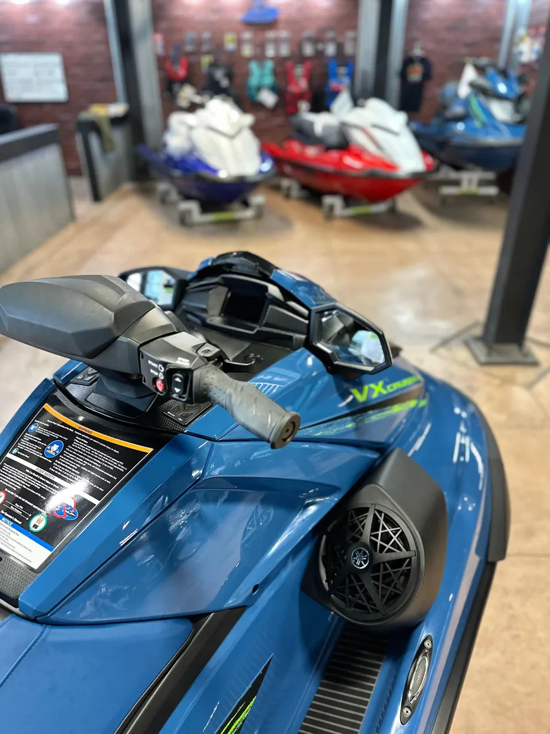 Slide: The Image of 2025 Yamaha WaveRunner VX Cruiser HO in showroom, blue with advanced controls. - 3