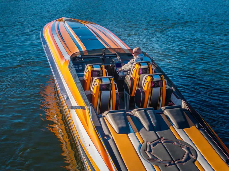 Slide: The Image of 2020 Fountain 47 Lightning speedboat with vibrant orange and yellow design on the water. - 4