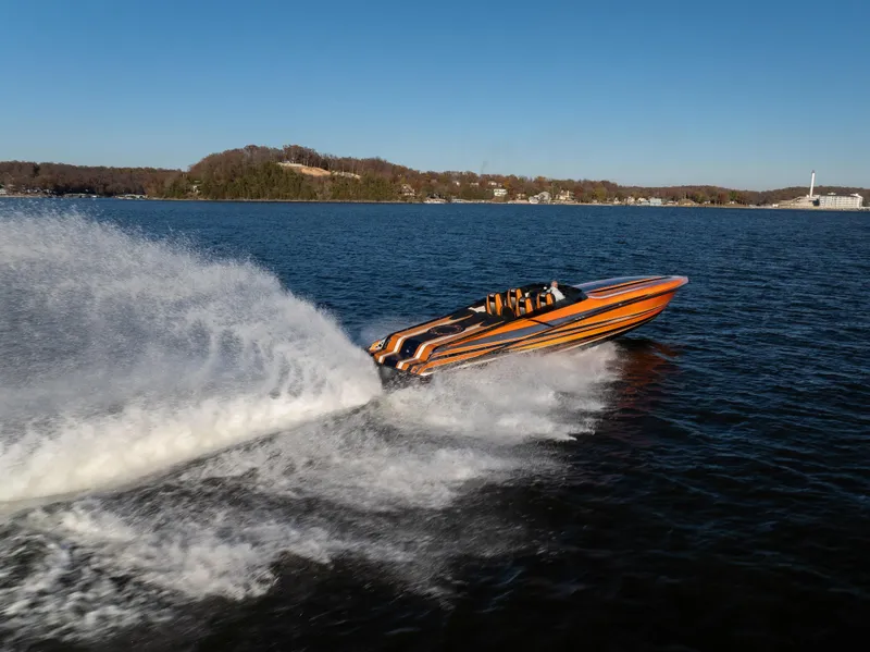 Slide: The Image of 2020 Fountain 47 Lightning speedboat racing on a lake, creating a large wake. - 7