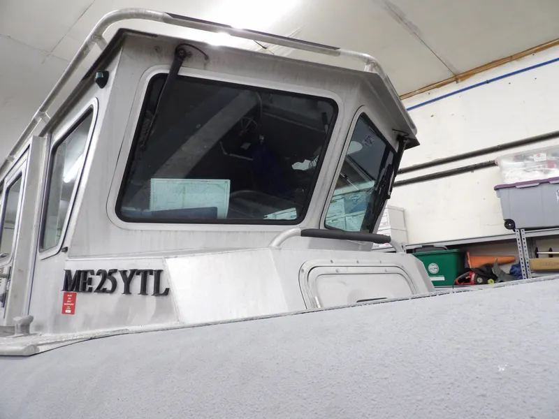 Slide: The Image of 2005 SAFE Boats Defender 25 in storage, close-up of cabin and windows. - 10