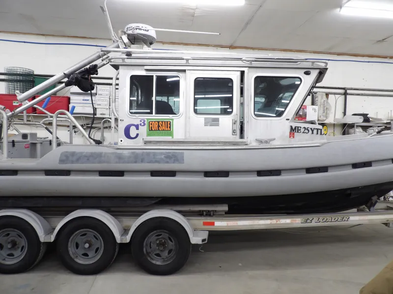 Slide: The Image of 2005 SAFE Boats Defender 25 on trailer, for sale in a garage setting. - 11