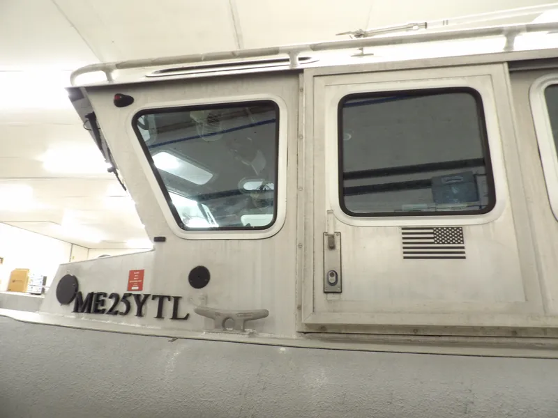 Slide: The Image of 2005 SAFE Boats Defender 25 cabin with American flag decal. - 18