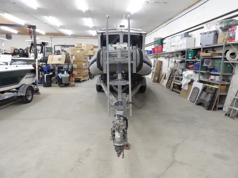 Slide: The Image of SAFE Boats Defender 25, 2005 model, in a storage facility with trailer. - 20