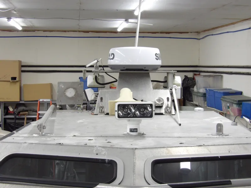Slide: The Image of 2005 SAFE Boats Defender 25 in a storage facility, showcasing radar and equipment. - 24