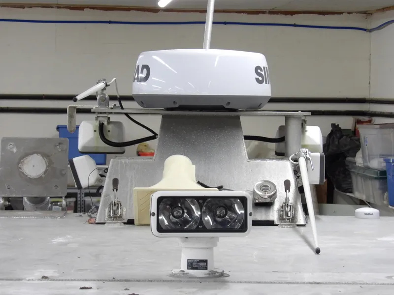 Slide: The Image of 2005 SAFE Boats Defender 25 radar and equipment setup in a workshop. - 25